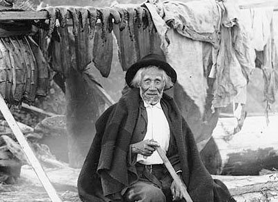 Salishan man named William We-ah-lup smoking salmon, Tulalip Indian Reservation, Washington, 1906